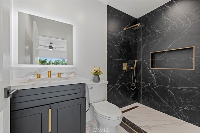 bathroom featuring ceiling fan, vanity, a shower, and toilet