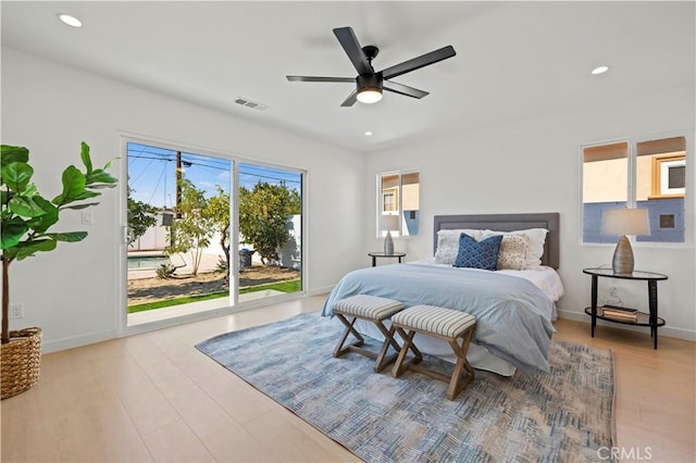 bedroom featuring ceiling fan, light hardwood / wood-style floors, and access to outside