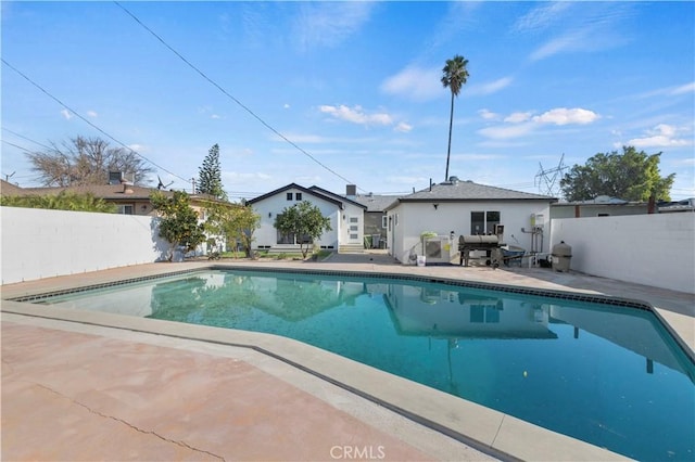 view of pool featuring area for grilling and a patio