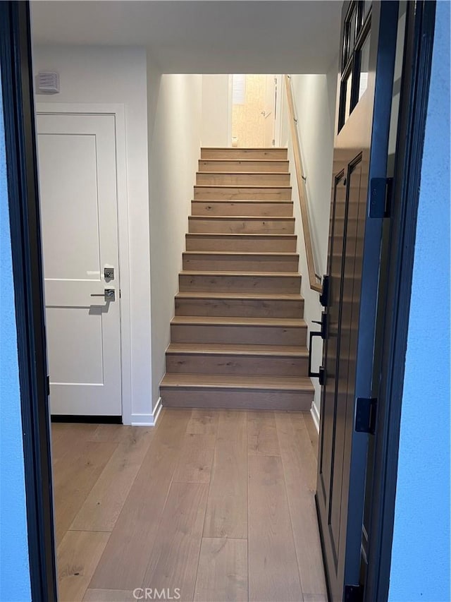 stairway with wood-type flooring