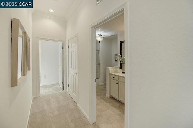 hallway with light carpet and ornamental molding