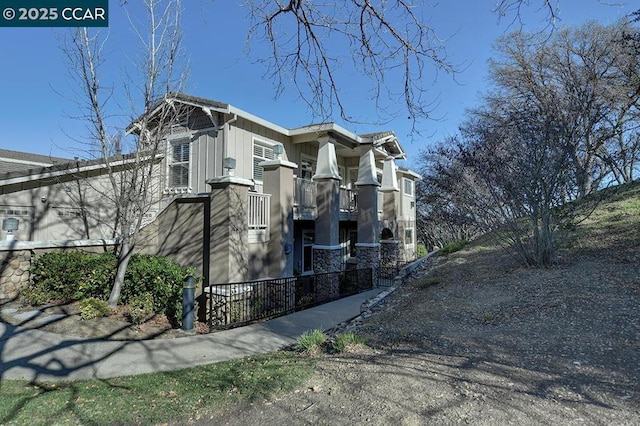 view of side of property with a balcony