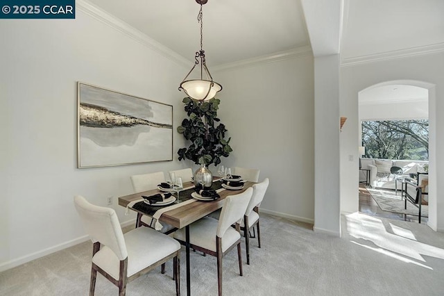 carpeted dining space featuring ornamental molding