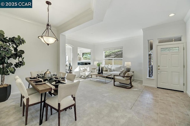 dining room featuring crown molding and light tile patterned floors