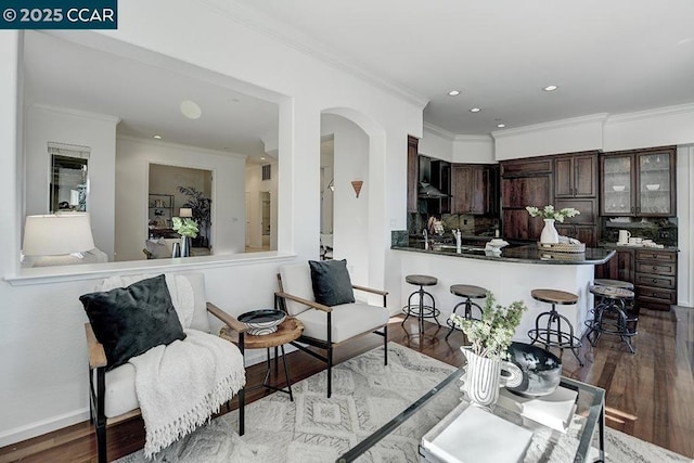 living room featuring wood-type flooring and ornamental molding