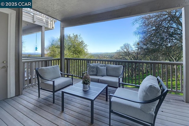 wooden terrace with an outdoor hangout area