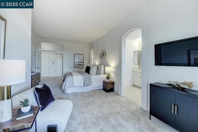 carpeted bedroom featuring ensuite bathroom