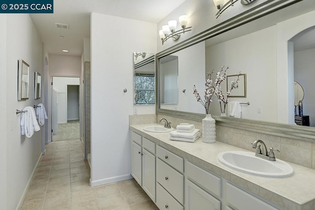 bathroom with tile patterned floors and vanity