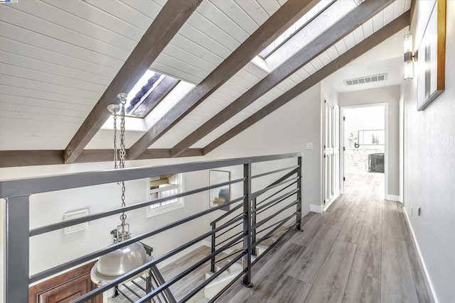 corridor featuring hardwood / wood-style floors, wood ceiling, and vaulted ceiling with beams