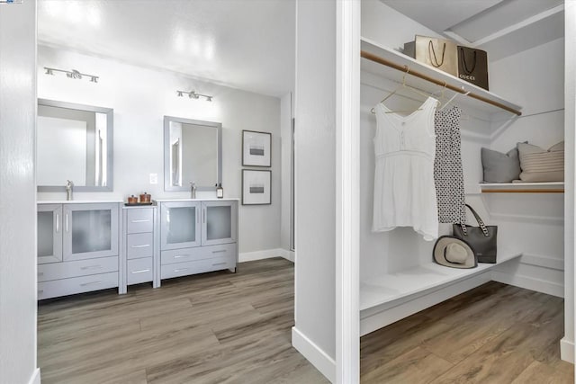 bathroom featuring a shower, vanity, and hardwood / wood-style floors