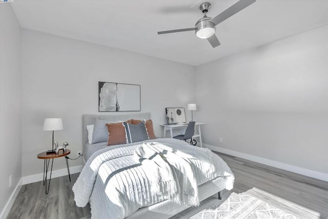 bedroom with ceiling fan and hardwood / wood-style floors