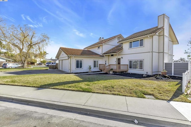 view of front of house featuring a front yard and a garage