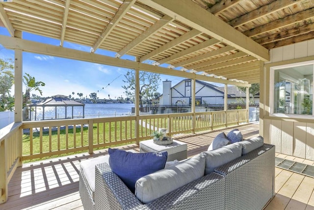 deck with a gazebo, outdoor lounge area, a lawn, and a water view