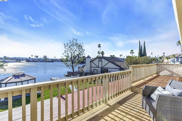 wooden deck with a water view and a gazebo