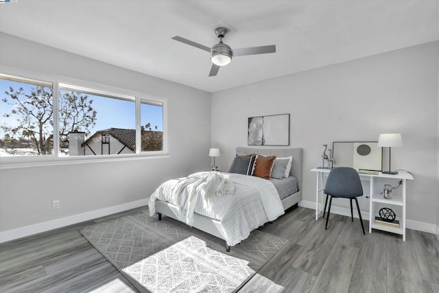 bedroom with ceiling fan and hardwood / wood-style flooring