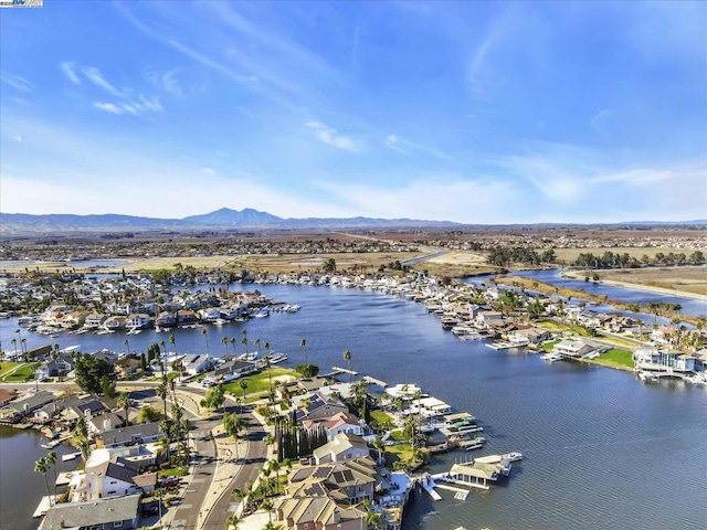 birds eye view of property featuring a water and mountain view