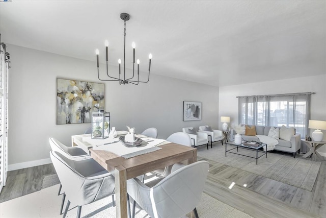 dining room featuring an inviting chandelier and light wood-type flooring