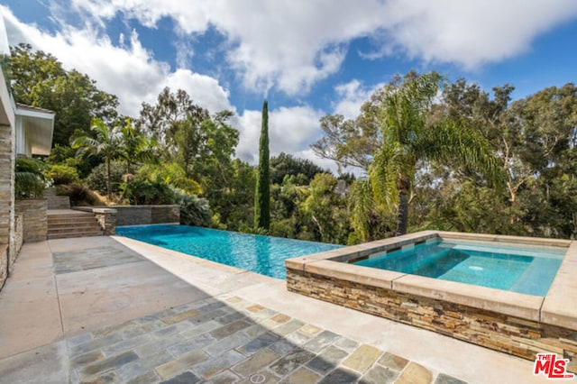 view of swimming pool featuring a patio area