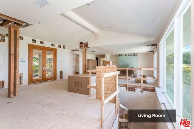 interior space with french doors and lofted ceiling with beams