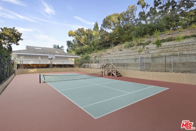 view of tennis court featuring basketball court