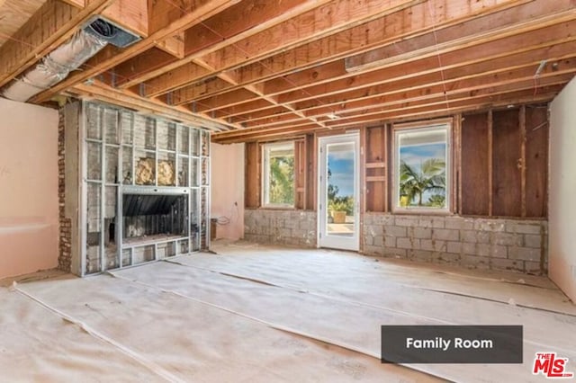 miscellaneous room with concrete floors and a fireplace