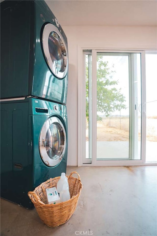 washroom with stacked washing maching and dryer