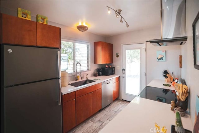 kitchen with sink, ventilation hood, and appliances with stainless steel finishes