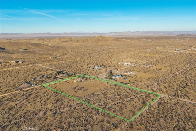 birds eye view of property featuring a mountain view