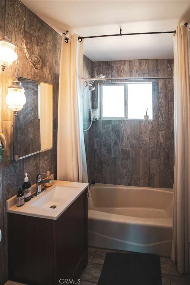 bathroom featuring shower / tub combo with curtain, vanity, and tile walls