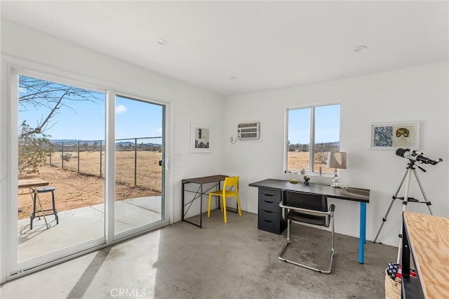 office area with an AC wall unit and concrete floors