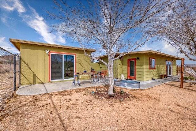 back of house featuring a patio area and fence