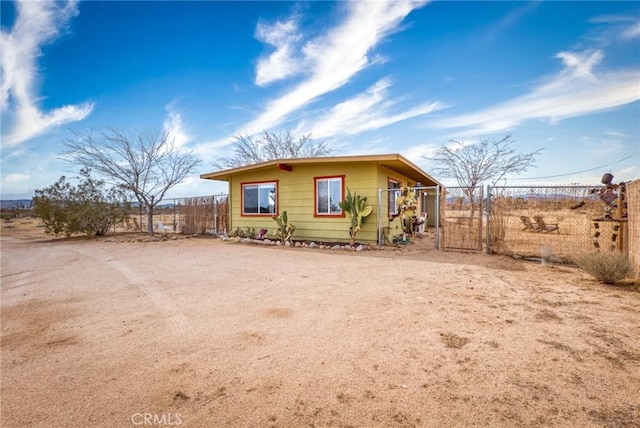 view of front of house featuring driveway and fence