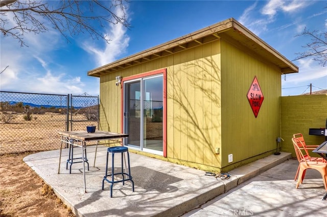 exterior space with outdoor dining space and fence