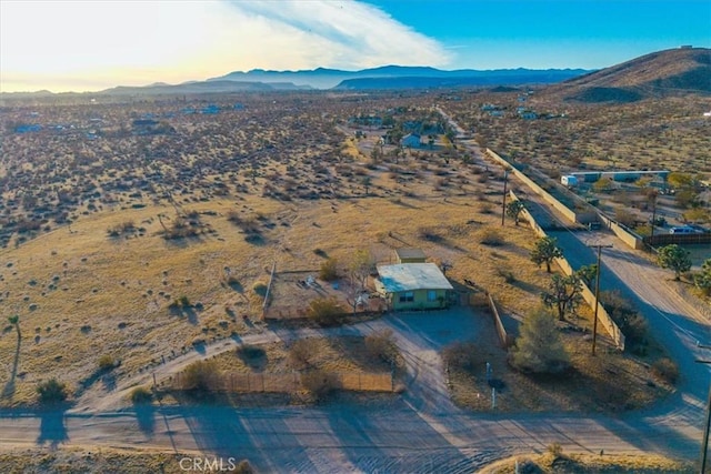 aerial view at dusk featuring a mountain view