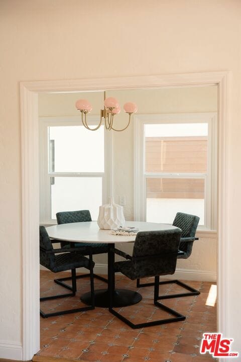 tiled dining area with an inviting chandelier and breakfast area