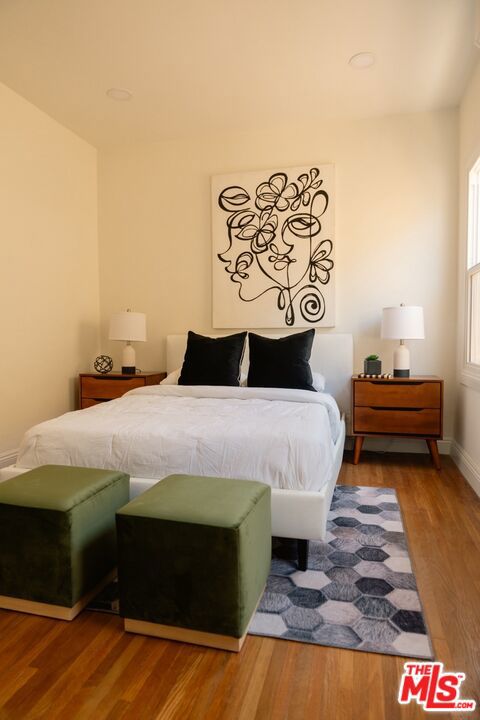 bedroom with wood-type flooring