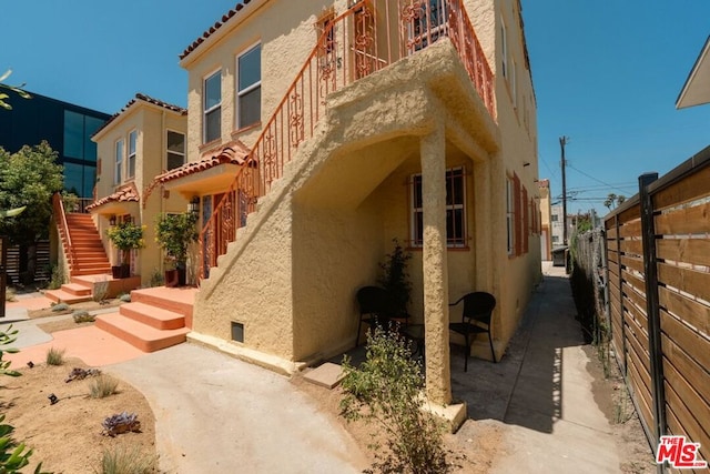 view of property exterior with a patio area