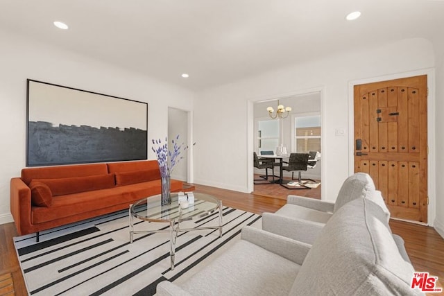 living room featuring a chandelier and hardwood / wood-style floors