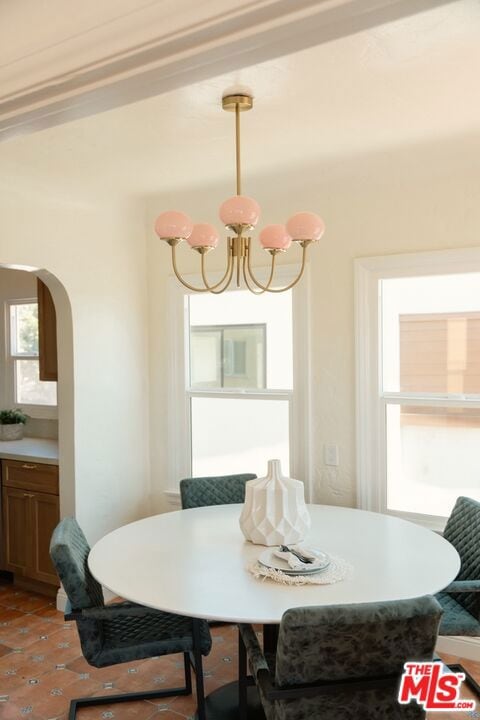 tiled dining space with breakfast area and a notable chandelier