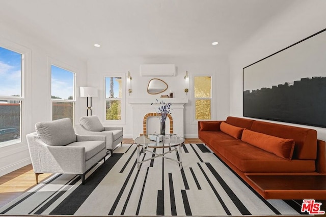 living room featuring a wall mounted AC and hardwood / wood-style floors