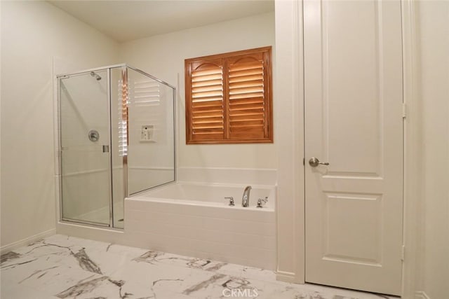 bathroom featuring independent shower and bath