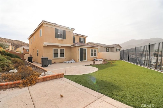 rear view of house featuring a lawn, central AC, a mountain view, and a patio