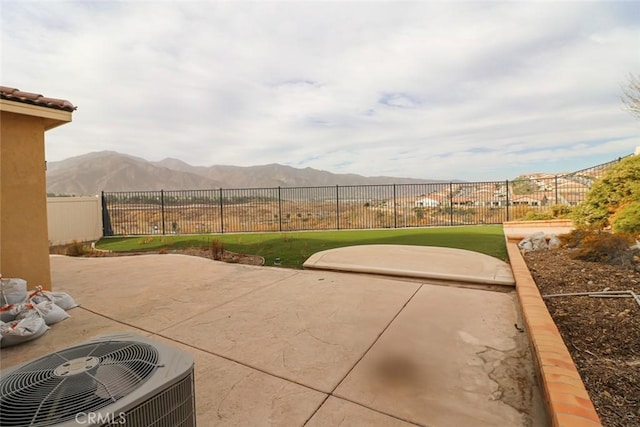 view of patio with central air condition unit and a mountain view