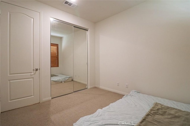 carpeted bedroom featuring a closet