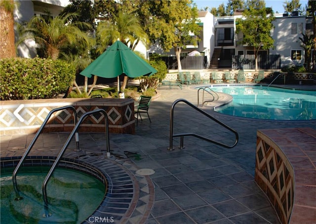 view of pool featuring a community hot tub and a patio