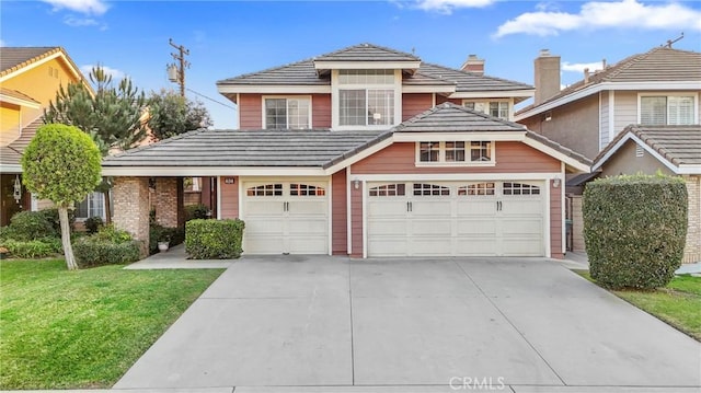 view of property featuring a garage and a front yard