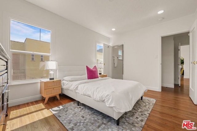 bedroom with hardwood / wood-style flooring