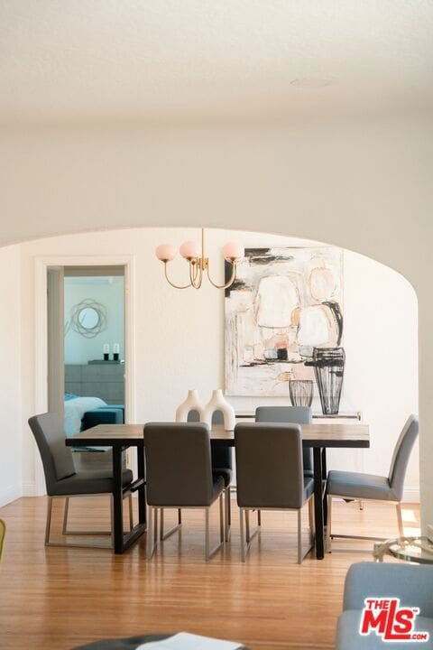 dining room with an inviting chandelier and wood-type flooring