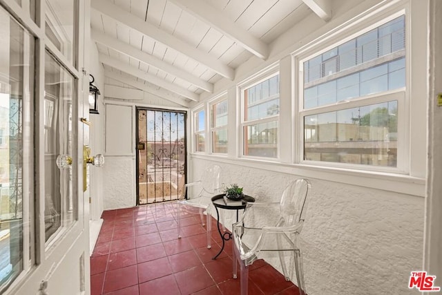 sunroom with vaulted ceiling with beams