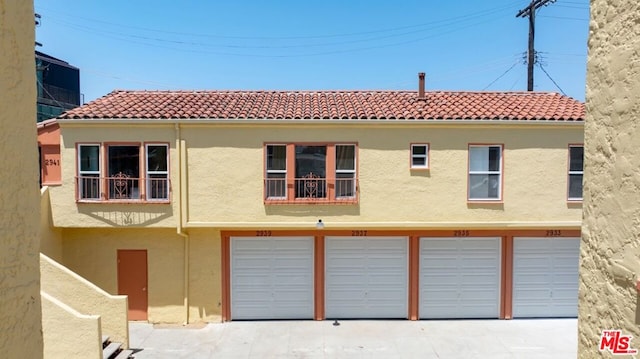 back of property with a garage